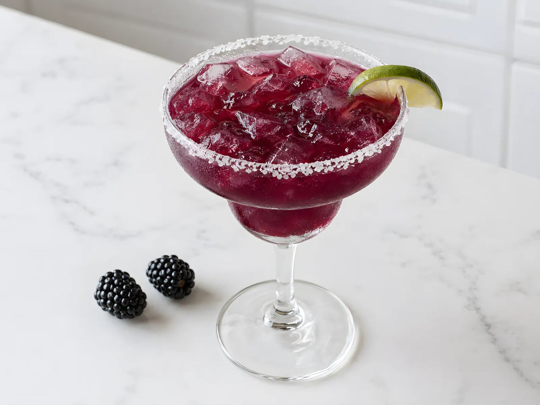A blackberry margarita on a home bar counter