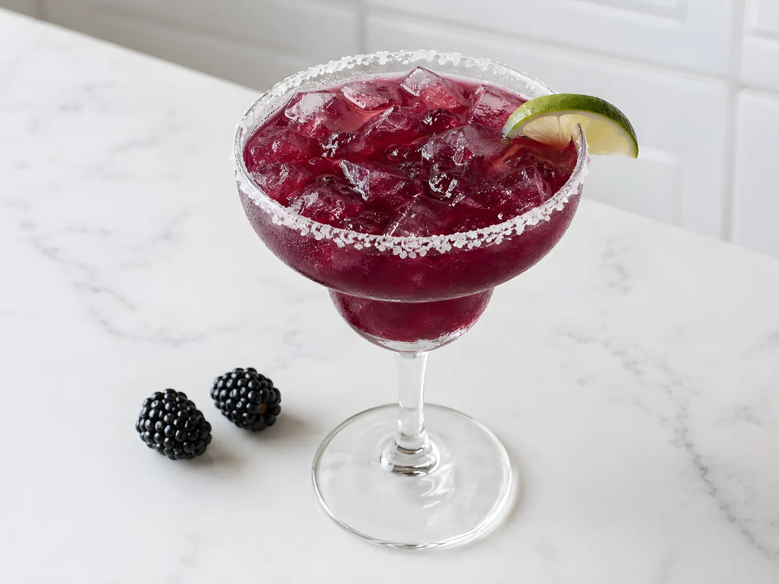 A blackberry margarita on a home bar counter