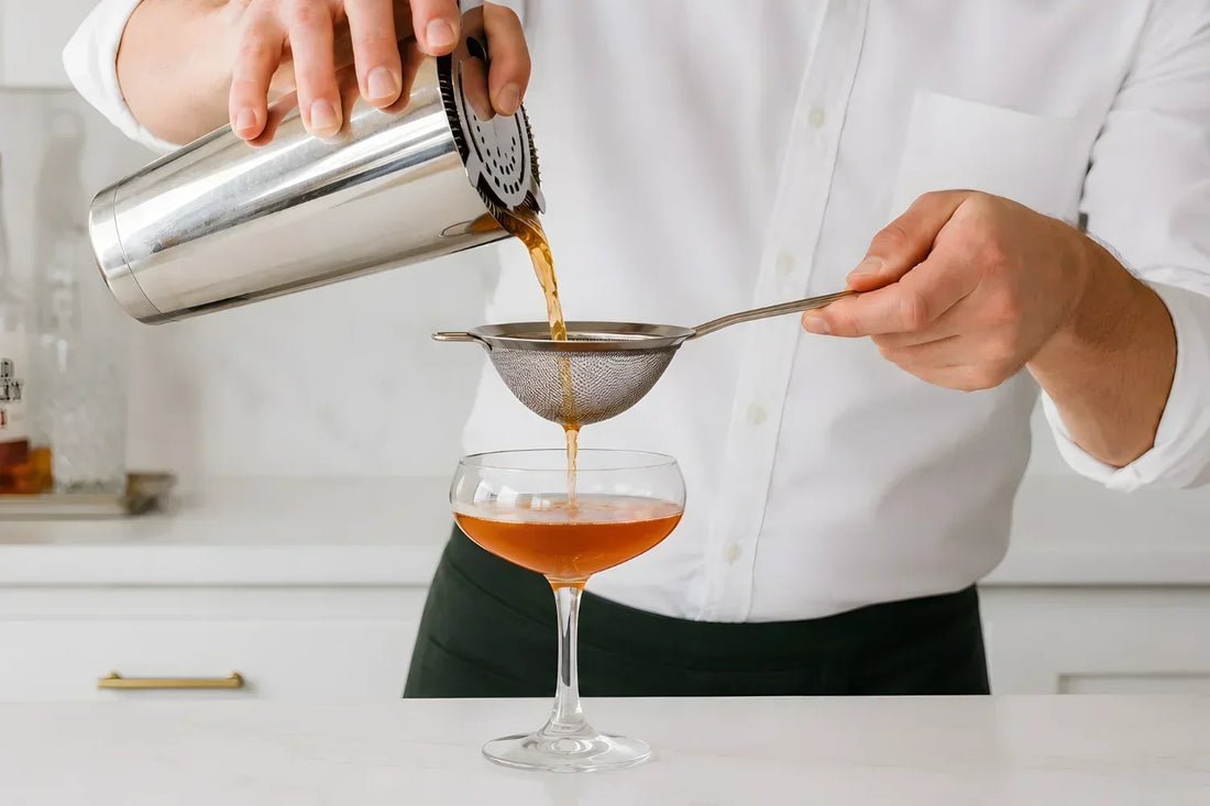 Bartender performing a double strain
