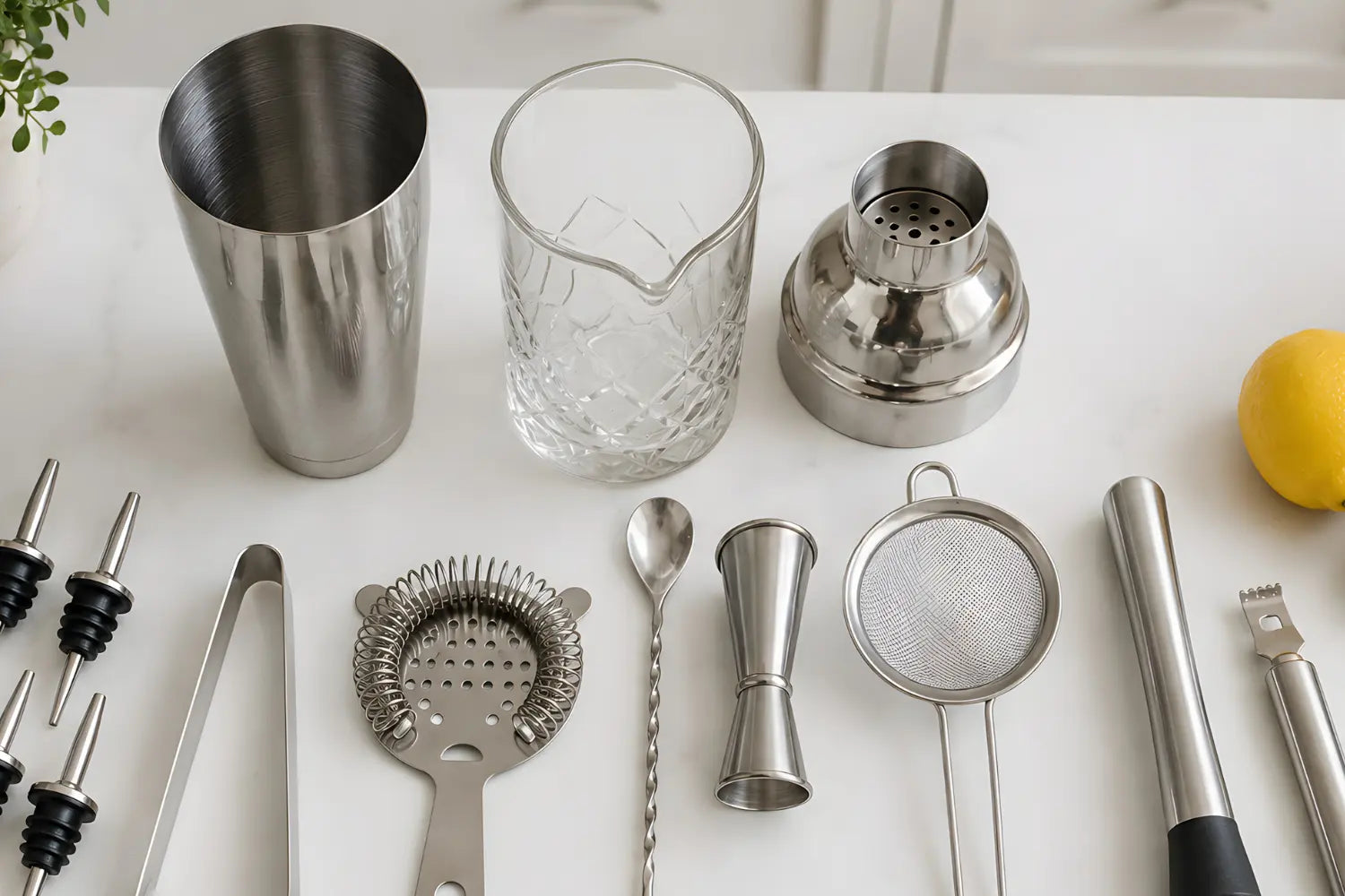 Essential home bar tools arranged on a counter