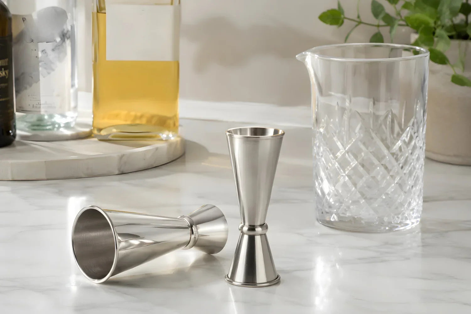 Two jiggers on a home bar counter