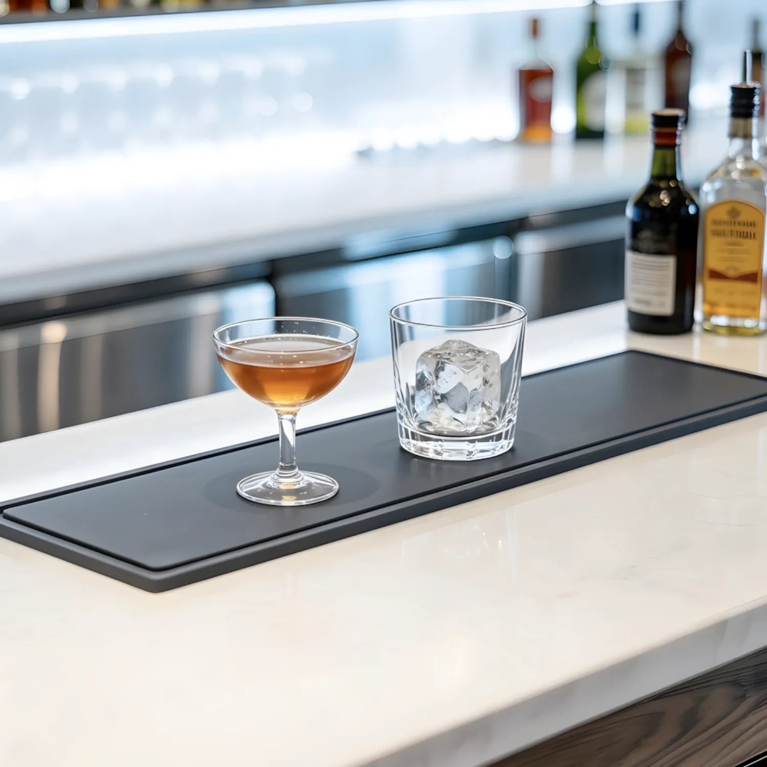 Two cocktails resting steadily on a bar mat