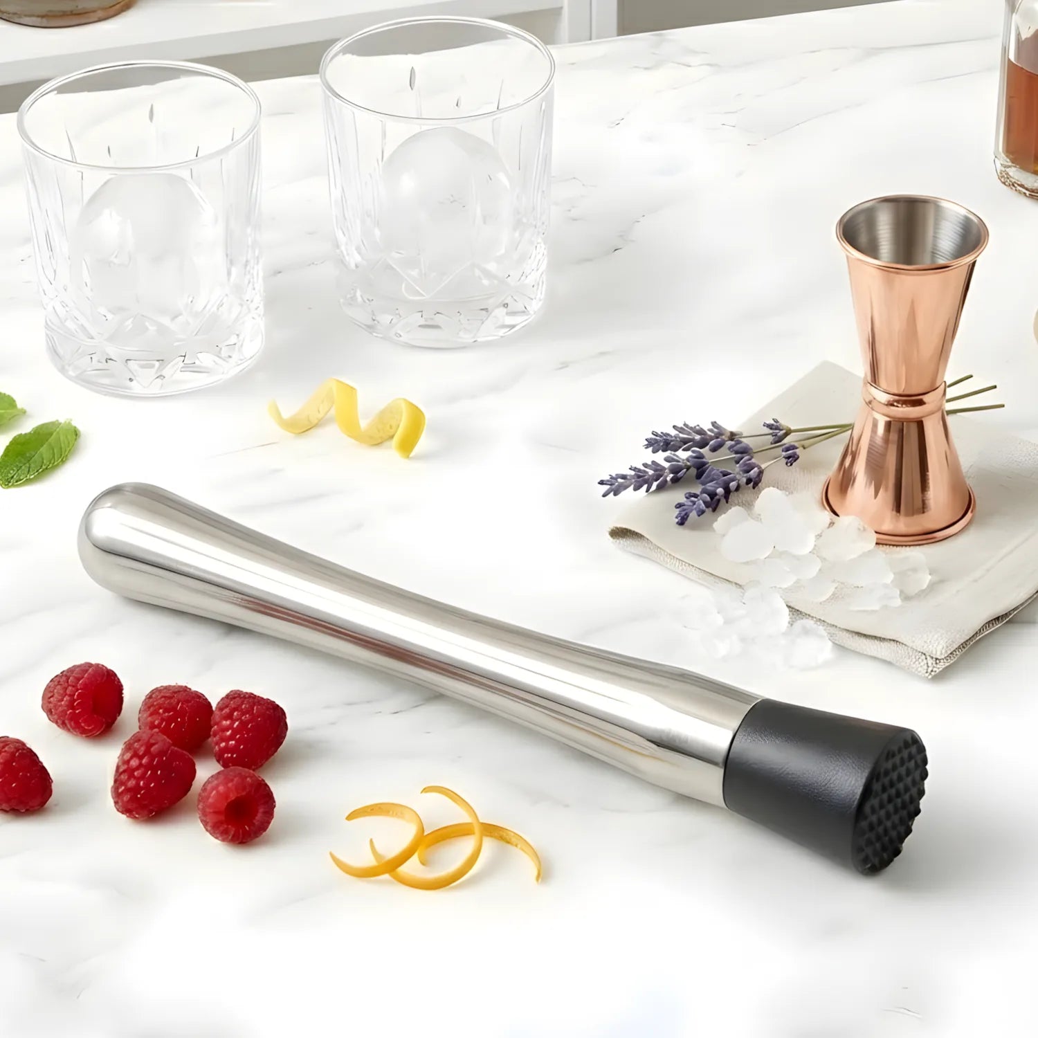 Stainless steel cocktail muddler on a home bar counter
