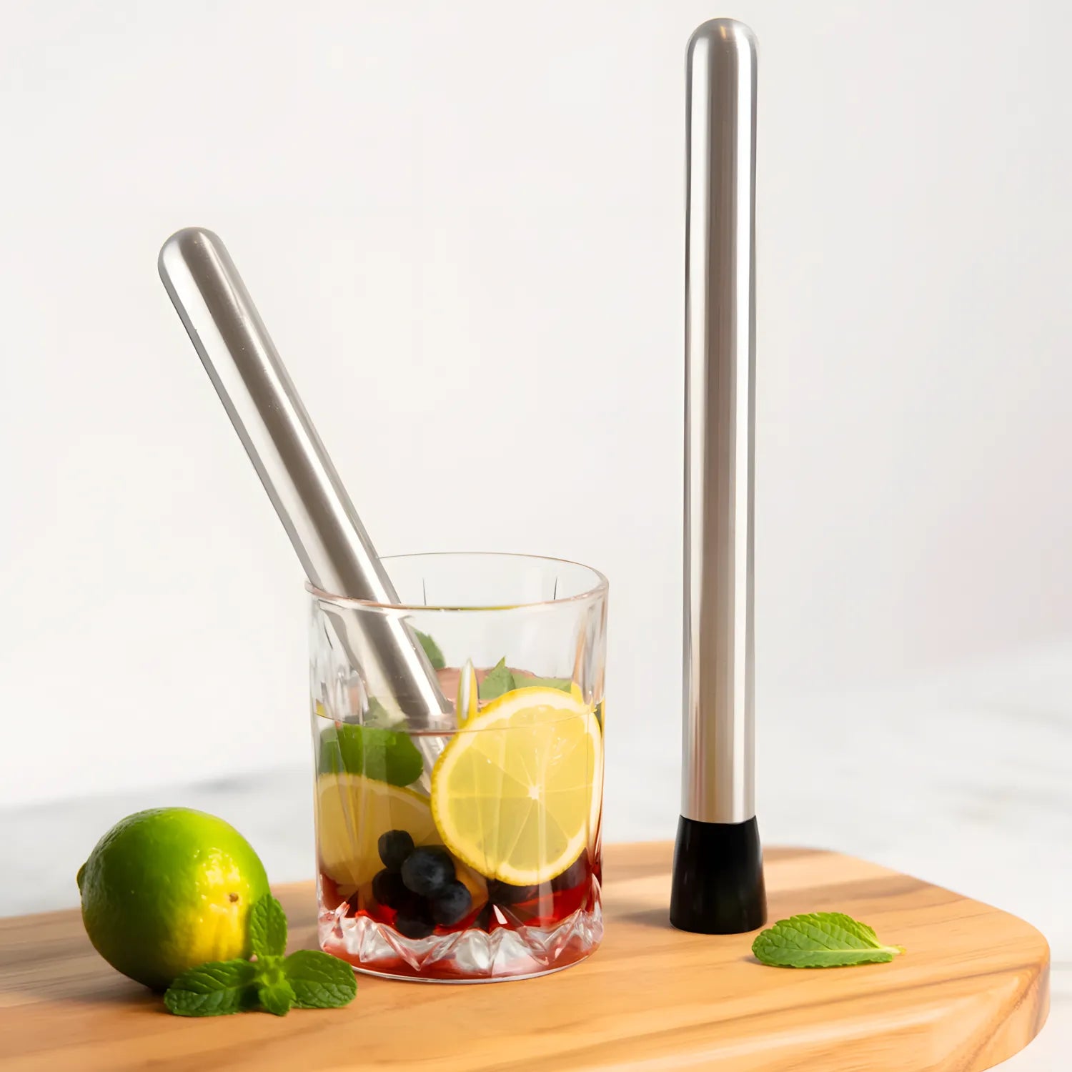 10 inch muddler next to a cocktail