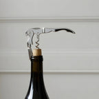 opening a bottle of red wine with a wine key
