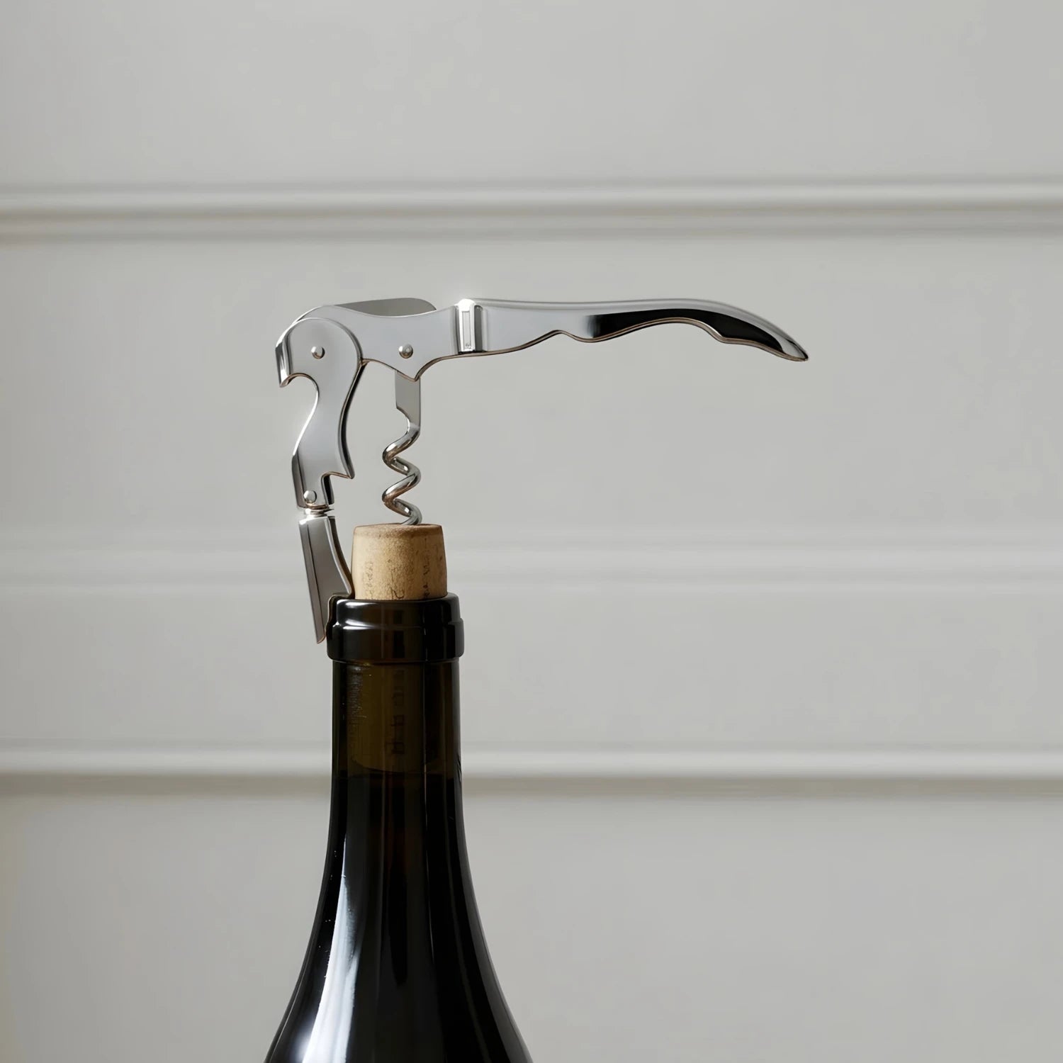 opening a bottle of red wine with a wine key
