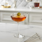 ball cocktail pick speared through a olive