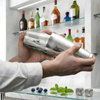 bartender shaking a Boston shaker at home bar