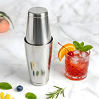 Boston shaker placed next to a finished cocktail