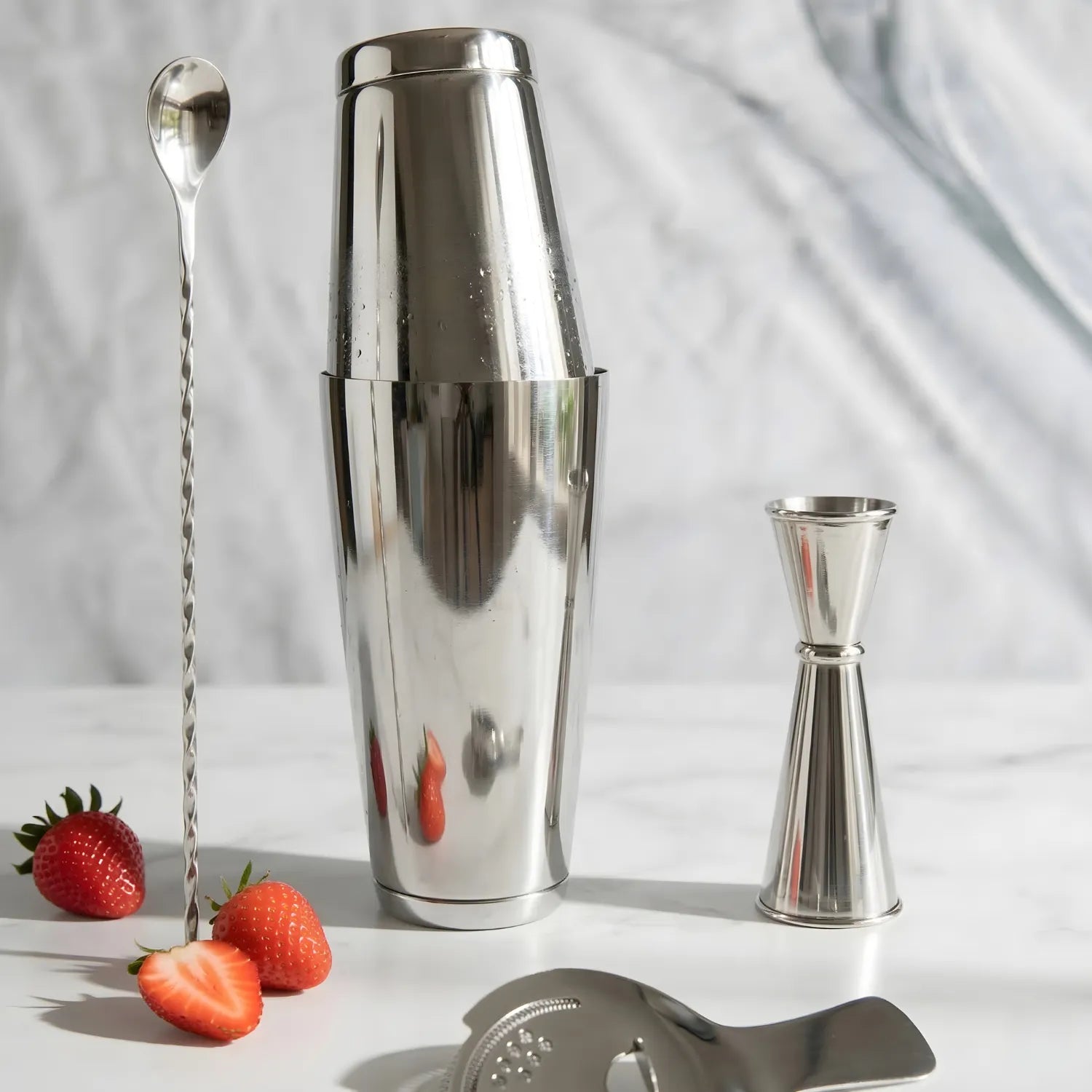 4-piece Boston shaker cocktail set on a home bar counter