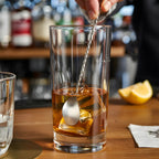 teardrop bar spoon is stirring in a glass