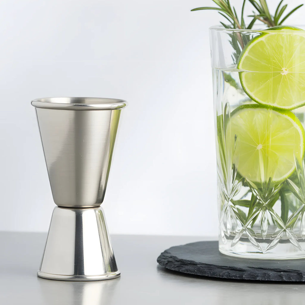 classic jigger next to a cocktail