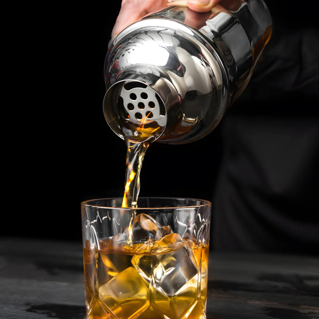 12 oz cobbler shaker pouring a cocktail into a glass