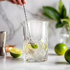stirring a cocktail in a diamond cut mixing glass