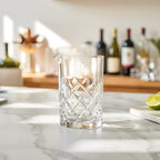 diamond cut mixing glass on a home bar counter