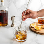 fork end bar spoon is stirring in a glass