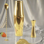 gold 4-piece Boston shaker cocktail set on a home bar counter