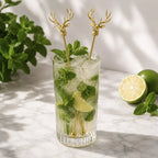 gold deer head swizzle sticks in a mojito