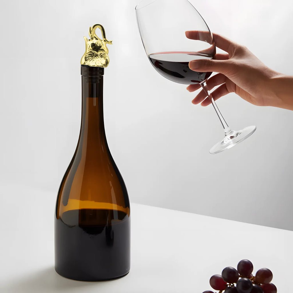 gold elephant pourer fitted on a bottle