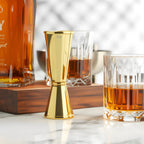 gold Japanese jigger on a home bar counter