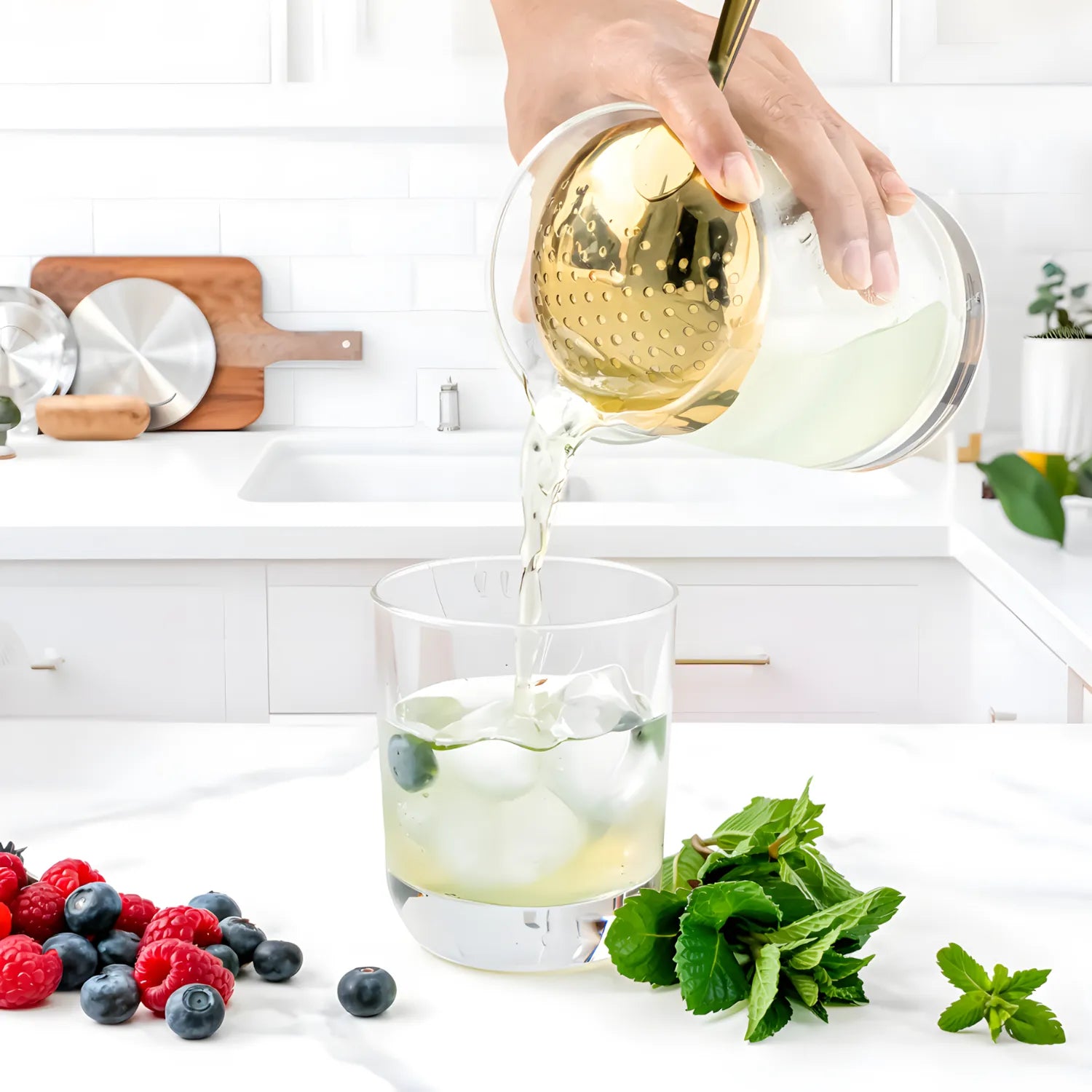 Bartender straining cocktail with a gold Julep strainer