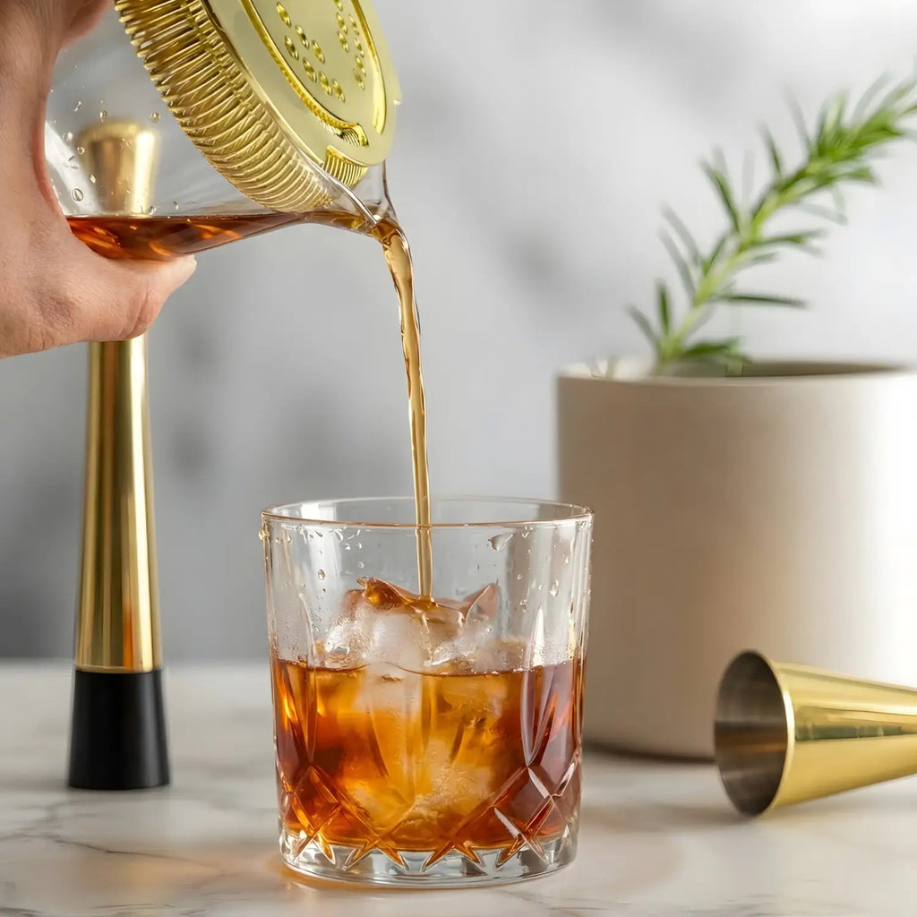gold mixing glass cocktail set in use