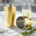 gold Parisian shaker taken apart and laid out on a table