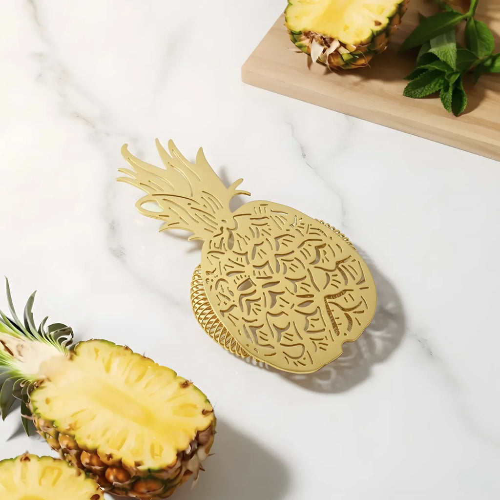 gold pineapple strainer on a home bar counter