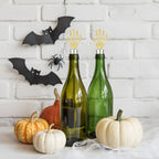gold skeleton hand wine stoppers fitted on bottles