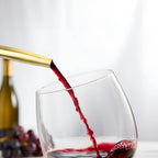 bottle with a gold speed pourer in use
