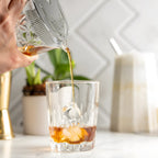 Bartender straining cocktail with a Hawthorne strainer