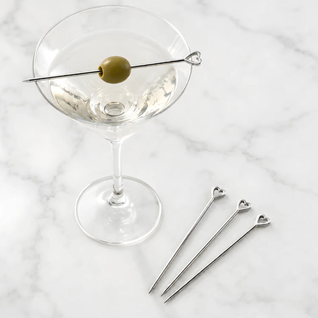 heart cocktail picks placed on a martini glass