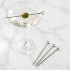 heart cocktail picks placed on a martini glass