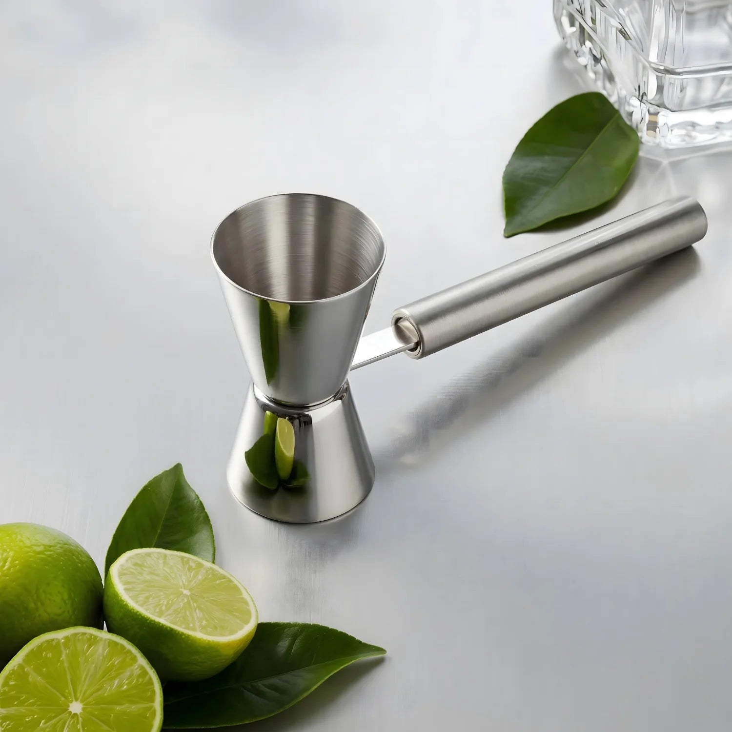 handled jigger next to limes