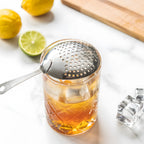 Julep strainer resting on a mixing glass