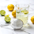 Julep strainer next to a mixing glass