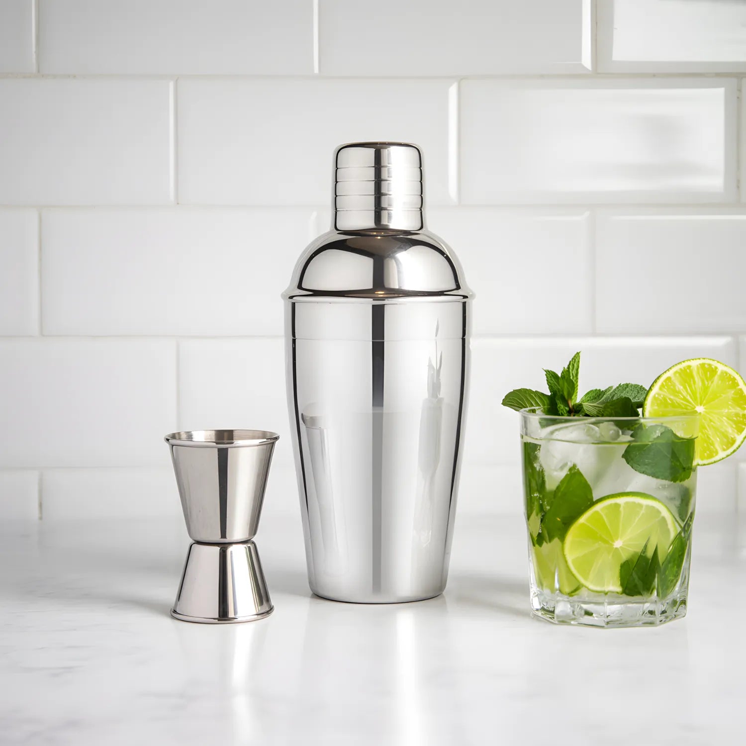 mini cobbler shaker cocktail set next to a cocktail