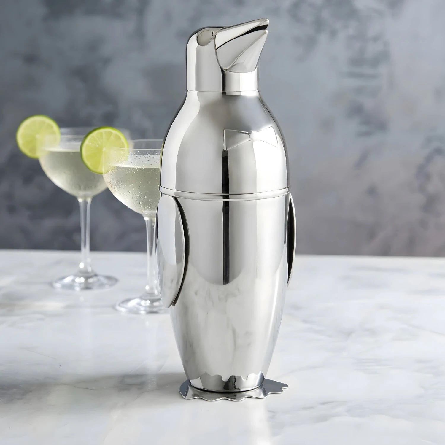 penguin cocktail shaker placed next to cocktails