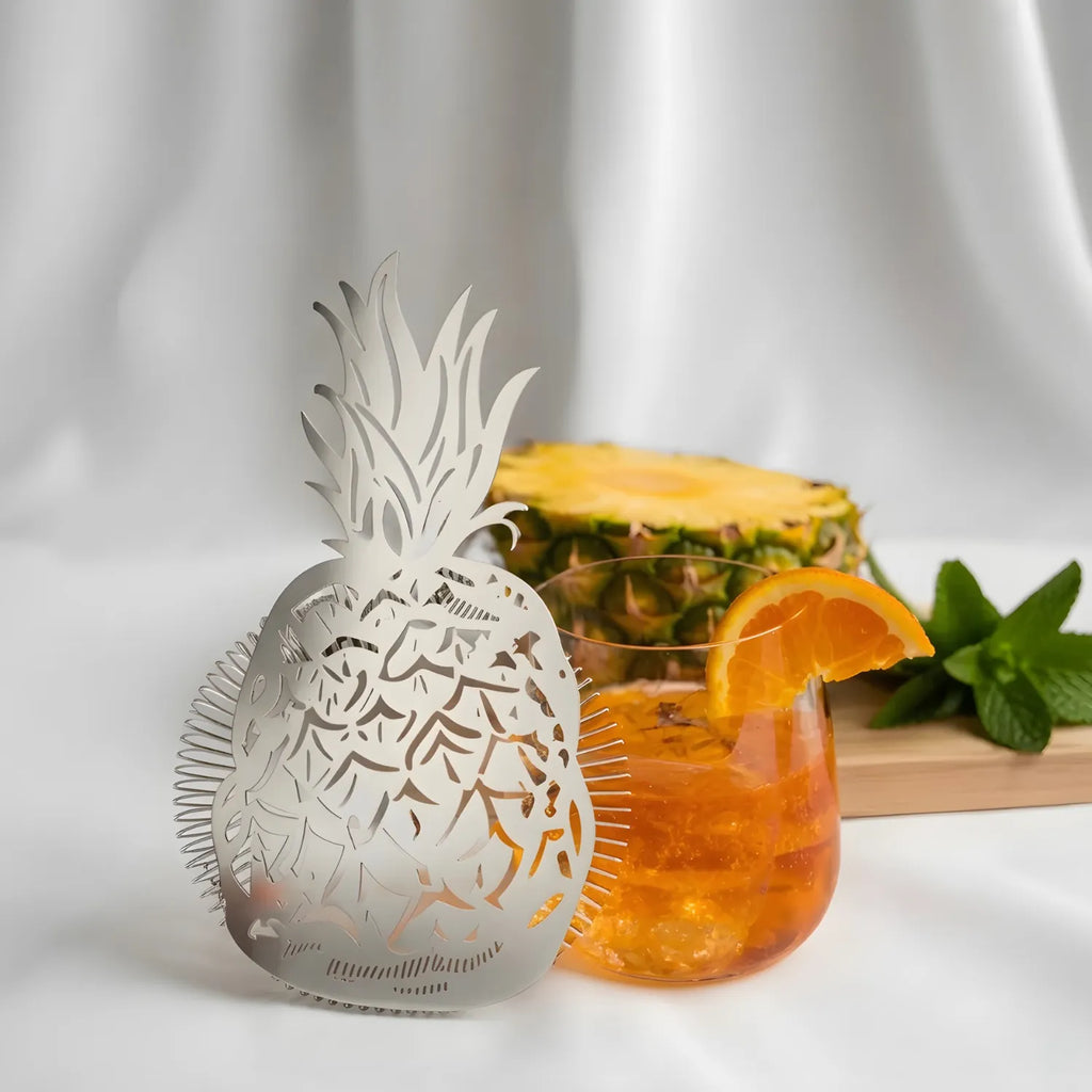 pineapple strainer next to a cocktail
