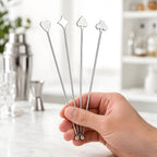 playing card swizzle sticks in hand