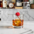 ring cocktail pick speared through a raspberry
