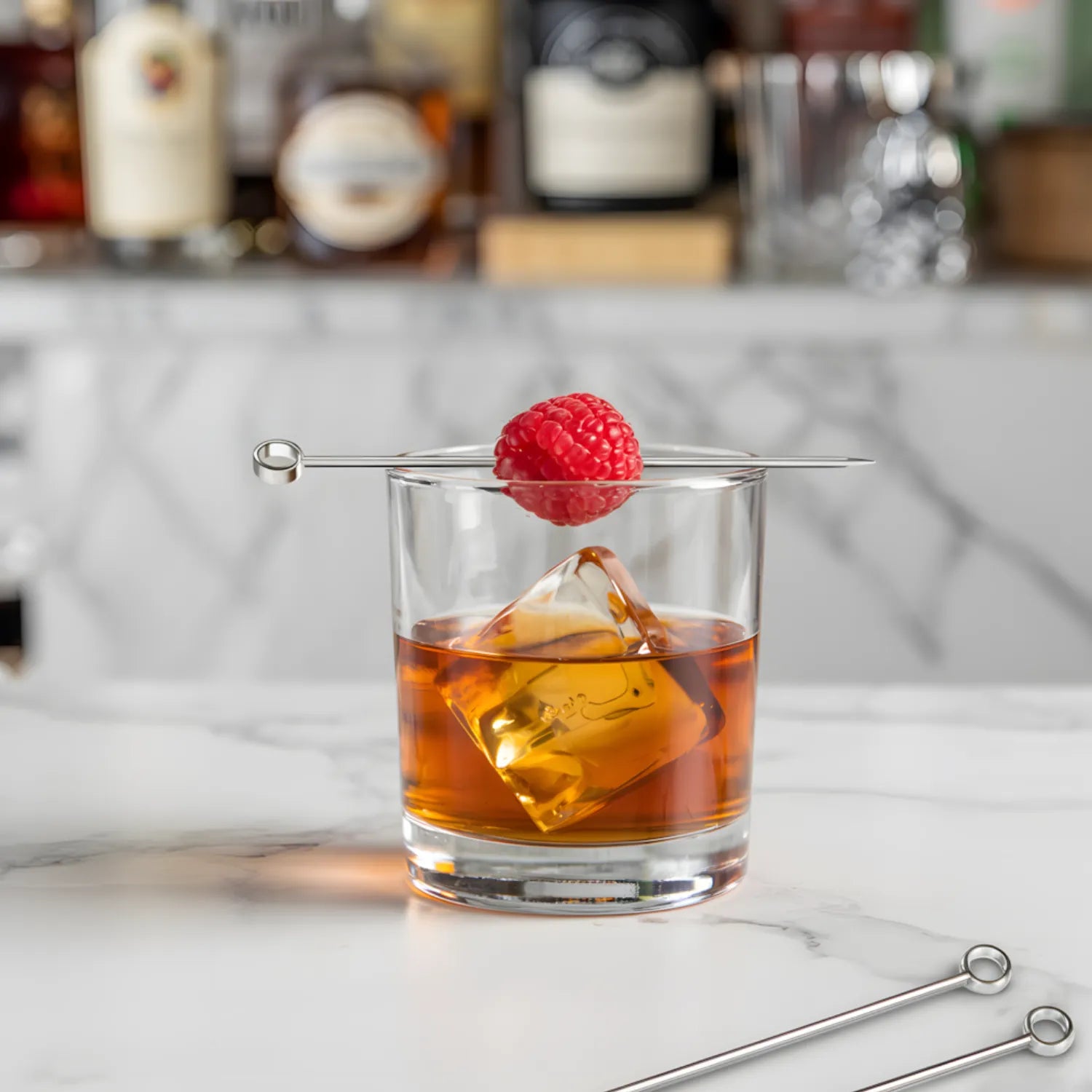 ring cocktail pick speared through a raspberry