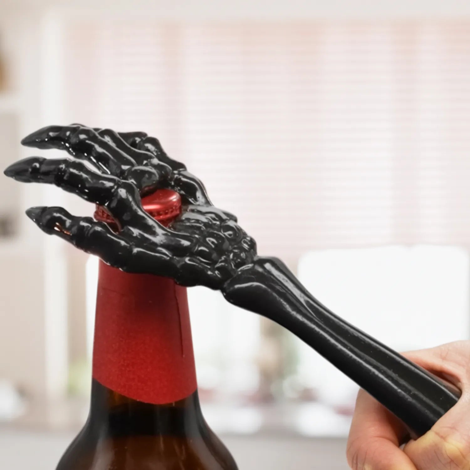 skeleton hand bottle opener in use