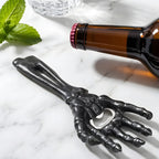 skeleton hand bottle opener on a home bar counter