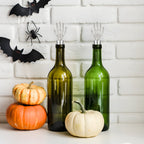 skeleton hand wine stoppers fitted on bottles
