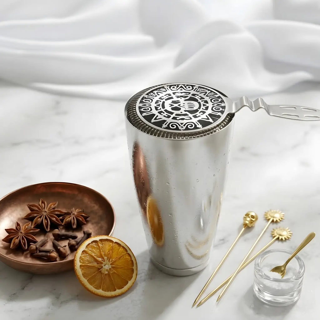 skull strainer resting on a shaker tin