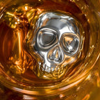 close-up of a skull stainless steel ice cube in a whiskey glass