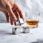 hand holding a stainless steel ice cube