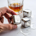 close-up of a stainless steel ice cube in hand