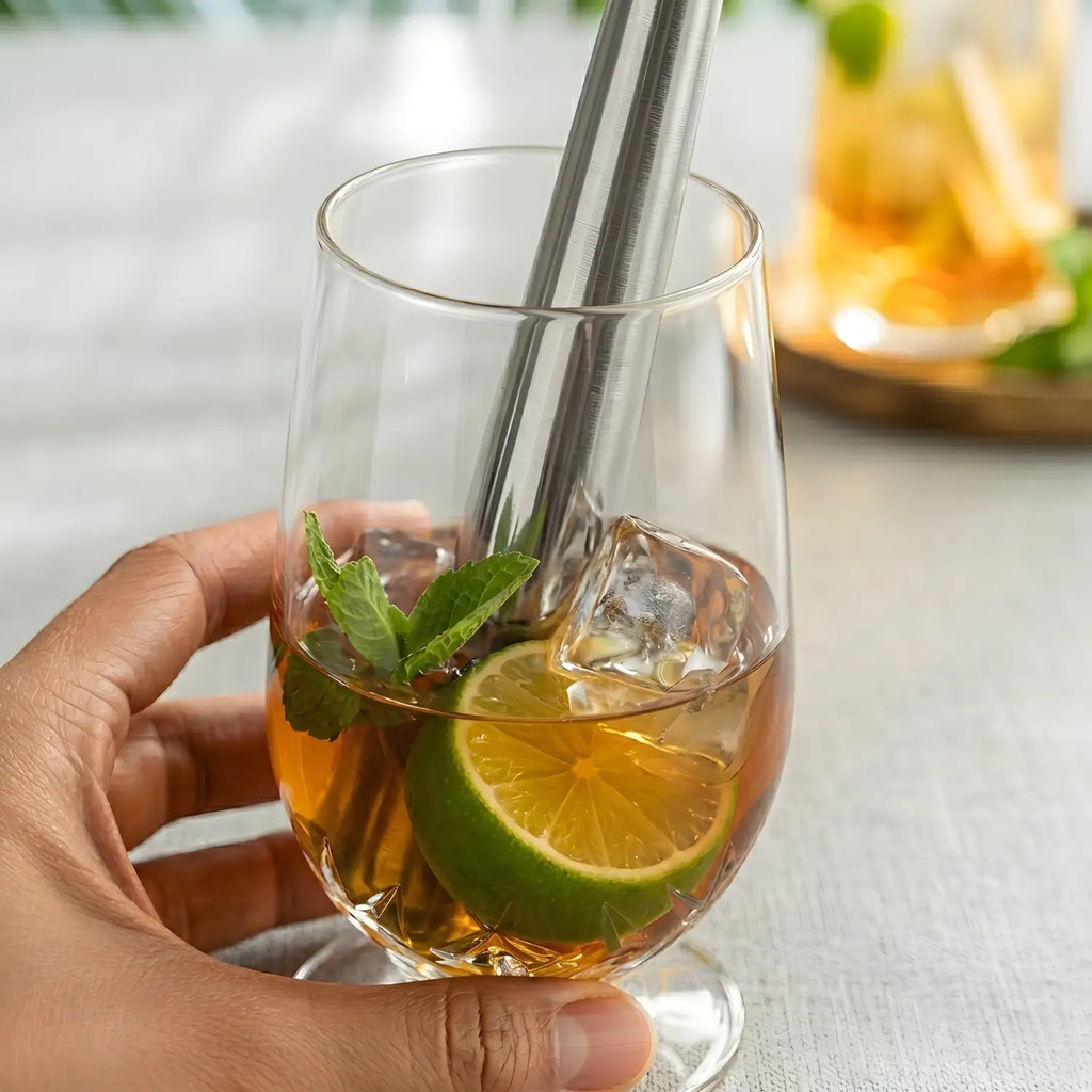 Bartender muddling mint with a stainless steel muddler